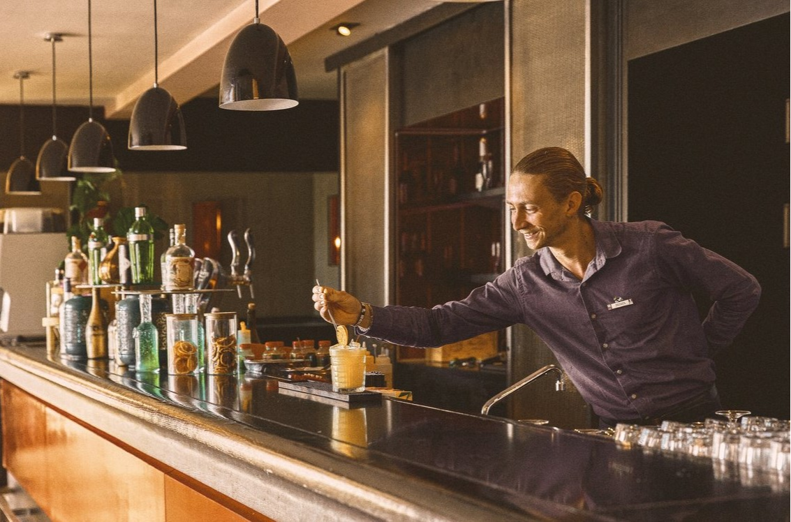 Bartender at Club Med Opio in Provence garnishing an orange cocktail to provide a refreshing experience. Bartender at Club Med Opio in Provence garnishing an orange cocktail to provide a refreshing experience.