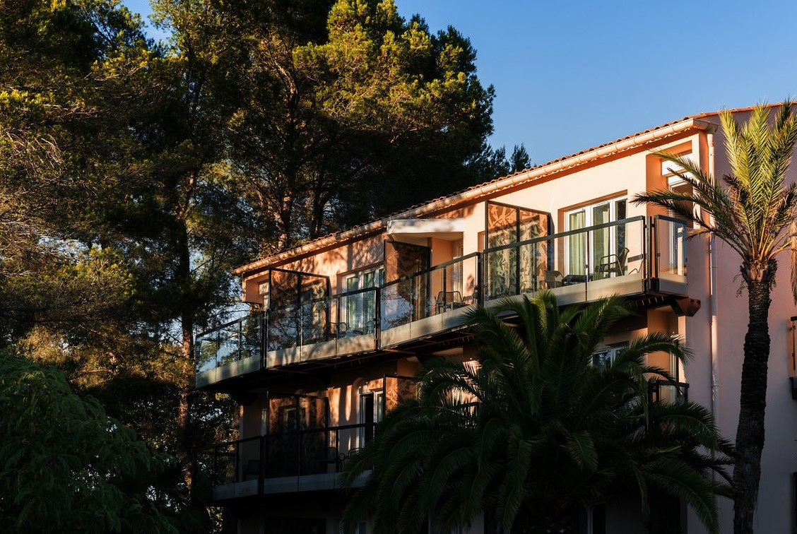 Façade des chambres avec balcons du Club Med Opio en Provence offrant une vue apaisante sur les arbres et la nature environnante. Façade des chambres avec balcons du Club Med Opio en Provence offrant une vue apaisante sur les arbres et la nature environnante.