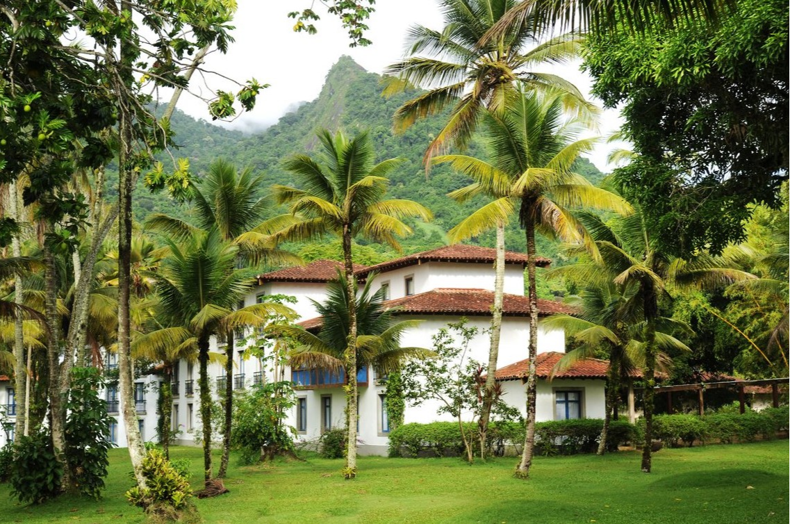 The Club Med Rio Das Pedras resort surrounded by palm trees and overlooked by tropical mountain scenery. The Club Med Rio Das Pedras resort surrounded by palm trees and overlooked by tropical mountain scenery.
