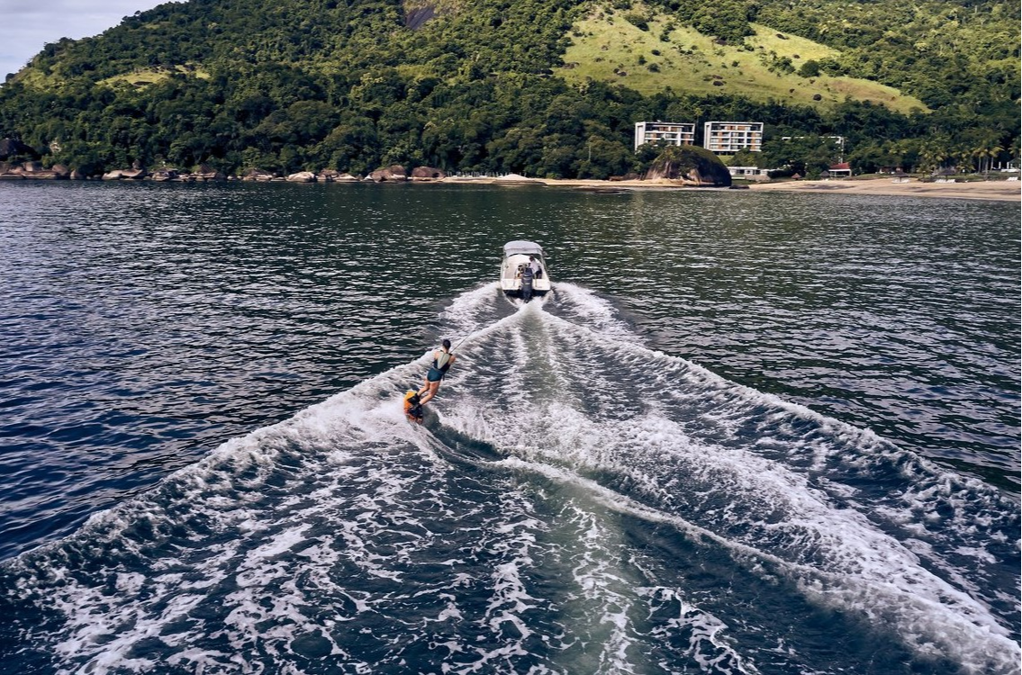 Woman wakeboarding on the blue waves of the Atlantic Ocean at Club Med Rio Das Pedras. An unforgettable aquatic adventure. Woman wakeboarding on the blue waves of the Atlantic Ocean at Club Med Rio Das Pedras. An unforgettable aquatic adventure.