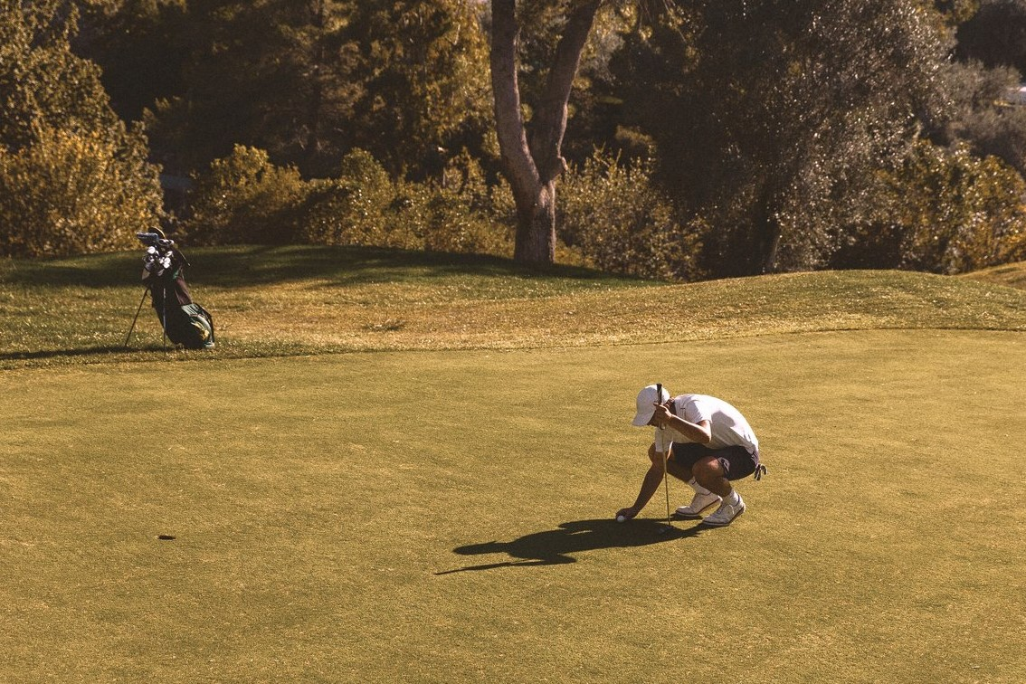 Man placing his ball on the green of the golf course at Club Med Opio in Provence, surrounded by a peaceful Provençal landscape. Man placing his ball on the green of the golf course at Club Med Opio in Provence, surrounded by a peaceful Provençal landscape.